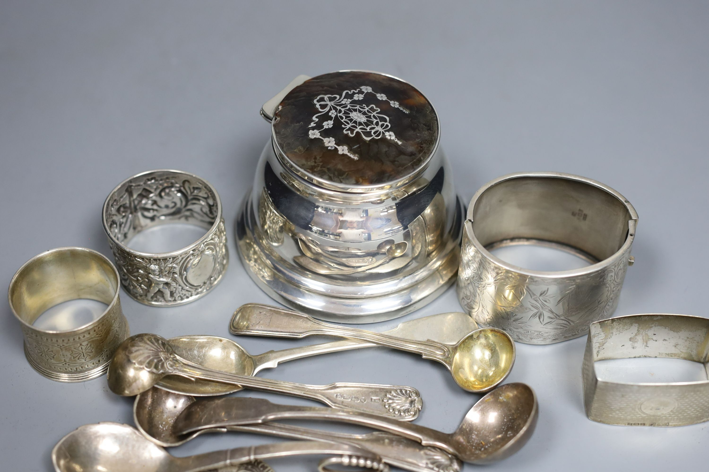 Assorted small silver including flatware, napkin rings, tortoiseshell mounted inkwell, two coins and a Georg Jensen sterling preserve spoon, no. 41.